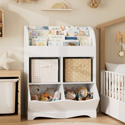 Keep all of your kiddo's favorite books, toys, and stuffed animals within reach with this 35'' bookshelf. With its scalloped details, it shows off a vertical design, complete with four shelves and two compartments, offering ample room for your favorite novels, decorative accents, and more. Made from engineered wood, this bookshelf has a finished back and a three-tier structure that adds visual interest to your room. We love that it comes with a wall anchor device for added safety. With its blend of form and function, this bookshelf is the ideal addition to your living room, bedroom, or home office. | Viv + Rae™ Kupang Cube Bookcase w / Display Shelf, White Wood in Brown / White | 35.1 H x 26.4 W x 15.7 D in | Wayfair Living Room And Playroom, Toy Storage Organizer, Bookcase With Drawers, Toy Storage Organization, Cube Bookcase, Corner Storage, Kids Bookcase, Bookshelves Kids, Fabric Drawers