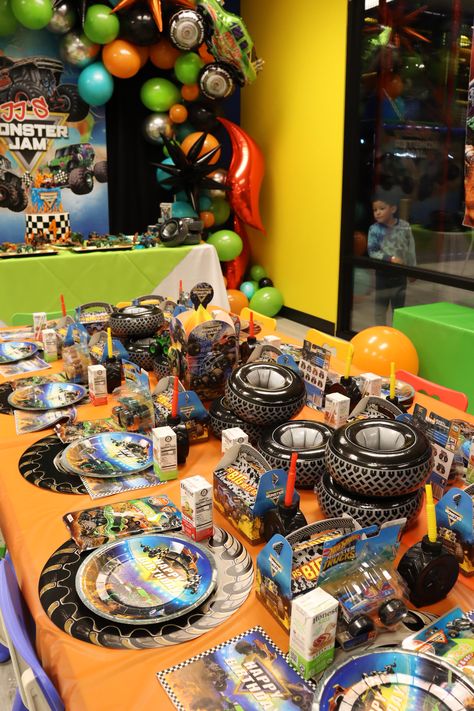 JJ's Monster Jam! JJ is Four! | CatchMyParty.com Monster Truck Party Table, Monster Truck Birthday Party Centerpiece, Monster Trucks Party Ideas, Monster Jam Balloons, Monster Truck Birthday Outfit, Cars And Monster Trucks Birthday, Monsters Truck Birthday Party Ideas, Monster Jam Goodie Bags Ideas, Monster Truck Birthday Table Decor