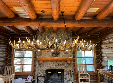 A custom Longs Peak Oval Elk Antler Chandelier in all its glory. This large lighting fixture is crafted with authentic antlers and illuminated with hidden wires to make a magnificent show-stopping centerpiece. It is ideal for positioning over a dining room table in a western design lodge. Antler Chandelier Dining Room, Antler Light Fixtures, Longs Peak, Antler Lights, Rustic Accessories, Rustic Coat Rack, Christmas Service, Antler Chandelier, Elk Antler