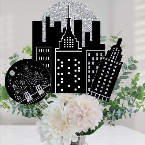 Nighttime City Skyline Centerpiece Sticks INCLUDES 15 Cityscape table toppers in three different shapes, 15 sticks, and stickers for easy assembly. NYC party table decorations are perfect for any New York City Party. Nighttime City Skyline Party Centerpiece Sticks SIZE 5 - Skyline Shape 1 Table Toppers (8.5” wide x 10.75” tall), 5 - Circle Shape 2 Table Toppers (5.25” wide x 5.25” tall), and 5 - Skyscraper Shape 3 Table Toppers (2.5” wide x 7.5” tall). The unique design and variety of pieces mak Red Black And Silver Centerpieces, Night In New York Theme Party, New York Centerpieces, Nyc Party Decorations, New York City Party Theme, New York Party Decorations, Nyc Centerpieces, New York Theme Party, York Candy