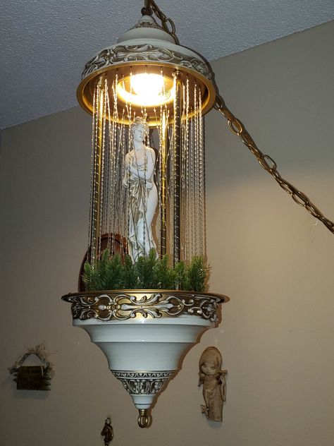 This lamp is about 32 inches long and uses two pints of mineral oil to create the rain. The oil is moved by a pump in the lower basin through a hose that runs up one of the columns into the top section. It then drips down the filaments through several holes in the top and back down to the bottom. Oil Rain Lamp, Rain Lamp, Oil Drip, Peaceful Home, Mineral Oil, Macrame Plant Hanger, Plant Hanger, The Rain, Lamps