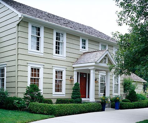 White molding adds classic style to this simple facade. See more ways to update your home: http://www.bhg.com/home-improvement/exteriors/curb-appeal/make-a-better-first-impression/#page=15 Colonial Home Exteriors, Dutch Colonial Exterior, Dutch Colonial Homes, Colonial House Exteriors, Exterior Window, Window Trim Exterior, Colonial Exterior, Colonial Style Homes, Exterior Renovation