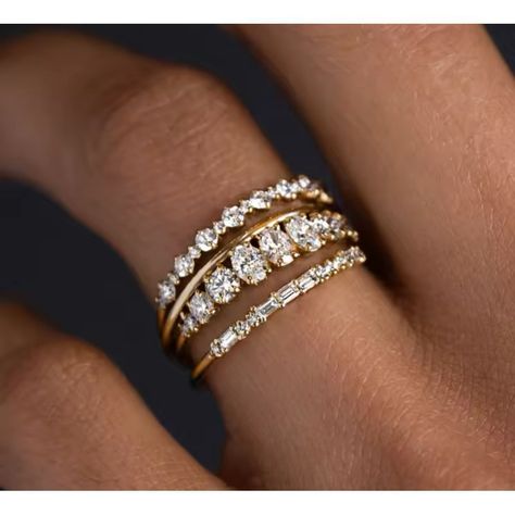 Stunning Triple Band Ring Set Featuring Brilliant Cubic Zirconia In A Luxurious Gold Setting. Each Band Showcases A Unique Design - One With Round Cubic Zirconia, Another With Baguette Cuts, And A Third With Graduated Stones. Perfect For Weddings, Anniversaries, Or Special Occasions. This Versatile Stack Can Be Worn Together For A Bold Statement Or Separately For A Delicate Look. The Intricate Design Adds Sophistication To Any Outfit, From Casual To Formal Wear. Main Stone: Cubic Zirconia Metal: Gold Band Wedding Rings, Ring Stack Gold, Diamond Ring Stack, Band Wedding Rings, Anniversary Bands For Her, Gold Wedding Band Set, Engagement Ring Baguette, Bridal Jewelry Gold, Band Diamond Ring