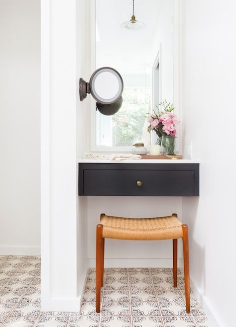 Gorgeous vanity nook features a black floating dressing table with white mirror above, and wall mount make-up mirror to the right, over a mid-century modern teak vanity stool atop hand painted terracotta floor tiles. Amber Interiors Bathroom, Vanity Nook, Bathroom With Makeup Vanity, Desks For Small Spaces, Bright Homes, Room Deco, Amber Interiors, Small Desk, Decorating Small Spaces