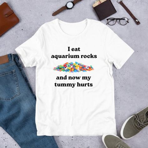 I Eat Aquarium Rocks, Funny Meme Shirt, Ironic Shirt, Oddly Specific Shirt Discover Our Latest Collection Of Versatile And Stylish T-Shirts (Gildan 5000), Where Fashion Meets Ultimate Comfort! Offered In Sizes Ranging From S To 3xl And A Vibrant Spectrum Of Colors Including Black, White, Sand, Green, Sport Grey, Red, Navy, And More, There's An Option To Cater To Every Taste. Crafted With Expertise Using Premium Materials, Our T-Shirts Provide A Luxurious Sensation And An Impeccable Fit That Last Bad Shirts Funny, Unhinged Tee Shirts, Unhinged T Shirts, Cursed T Shirts, Oddly Specific Shirts, Obese Fashion, Ironic Tshirt, Goofy Shirts, Cursed Shirts