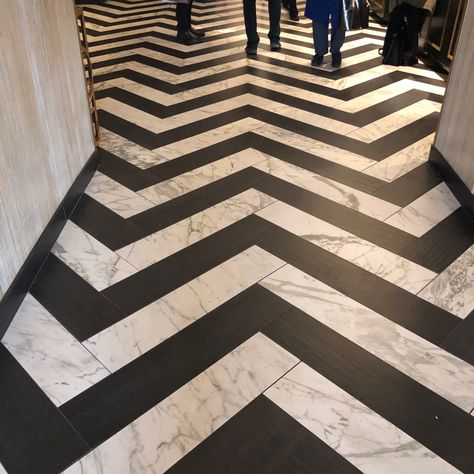 Have you considered mixing your tile styles? Wood and marble porcelains can be seen together in this awesome, en trend herringbone pattern. #hotel57nyc #dashdesignnyc #flooringfriday #tileenvy #porcelaintile #classicblackandwhite #blackandwhitedesign #classiccolors #ebonyandivory #contrast #interiordesign #tileporn #architecture #artigianalità #artisan #custom #customize #commercialdesign #construction #restaurantdesign #floortile #hospitalitydesign #tiletrends #ihavethisthingwithfloors Mixed Floors Wood And Tile, Black And White Striped Floor, Black And White Chevron Tile, Black Herringbone Tile Floor, White Herringbone Floor, Chevron Tile Pattern, Chevron Tiles Floor, Marble Herringbone Floor, Black Herringbone Tile