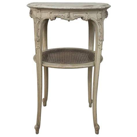 19th century French Louis XVI painted oval end table represents the essence of the classical form, with subtly transitional French-scrolled legs for added visual intrigue. Patinaed painted finish gives it a wonderful warmth, as does the lower caned shelf,circa 1890sMeasures: 29.5 H x 19 W x 15 D. Cane Shelf, Antique End Tables, Brass Side Table, Occasional Tables, Oval Table, Classical Architecture, Design District, Louis Xvi Style, Painted Table