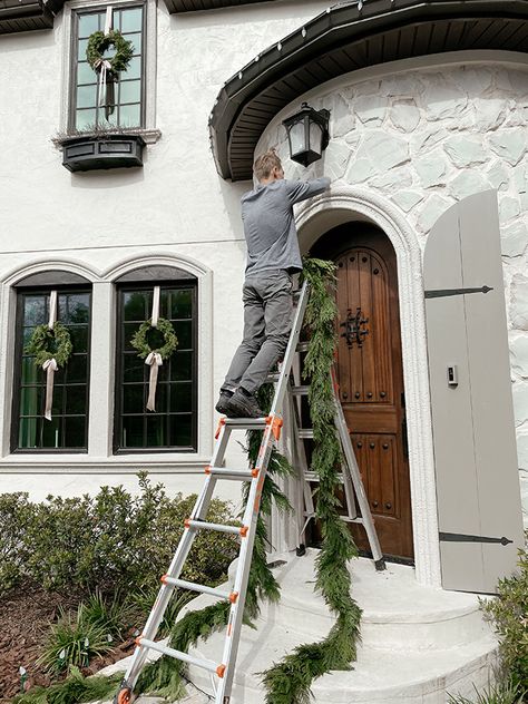 Heights House Christmas Exterior Stone House Christmas Decorations Exterior, Christmas Wreath Exterior Window, Classic Christmas Exterior, Christmas Exterior Window Decorations, Wreaths On House Windows, Christmas Wreaths Windows Outdoor, Colonial Christmas Exterior, Classy Exterior Christmas Decor, Exterior Christmas Wreaths On Windows