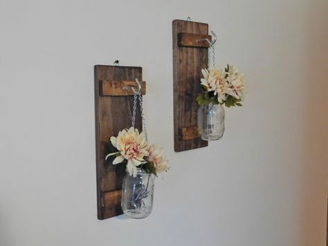 A Pair of Rustic Hanging Mason Jar Wall Sconces Great for displaying flowers or as a candle holder A great rustic decor addition to any home or office as well as wedding decorations Candles and flowers are not included and are shown for your viewing only Each board is approx 16 Tall and 5 1/2 wide with a hanging pint 16 oz Jar attached by a hanging silver chain This Listing is for a Set of Two Wood may vary slightly from what is shown in the photos as we try to use as much reclaime... Country Entryway, Candles Rustic, Mason Jar Decor, Hanging Mason Jars, Candle Wedding Decor, Rustic Mason Jars, Rustic Wall Sconces, Jar Decor, Sconces Bedroom