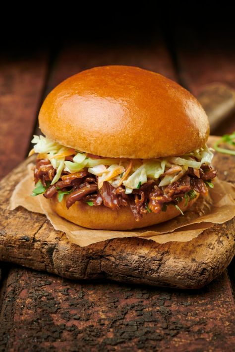 A close-up photo of a pulled pork burger on a wooden board on a table. Grilled Pulled Pork, Vinegar Bbq Sauce, Pulled Pork Burger, Bee Food, Paprika Pork, Recipe Email, Brioche Buns, French Twist, Burger Buns