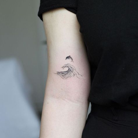 180+ Creative Dolphin Tattoos Designs with Meanings (2022) - TattoosBoyGirl Dolphin Tattoos, Wave Tattoo Design, Tato Minimal, Dolphins Tattoo, Small Shoulder Tattoos, Wave Tattoo, Whale Tattoos, Anklet Tattoos, Small Tattoos Simple