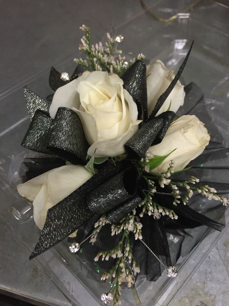 Corsage Prom Black And Gold, White Corsage With Black Ribbon, White Flower Black Ribbon Corsage, Black Corsage And Boutonniere Prom, Corsage To Go With Black Dress, Black Corsages For Prom, Corsage Prom Black And Silver, Black And White Wrist Corsage, Prom Wrist Corsage Ideas Black Dress