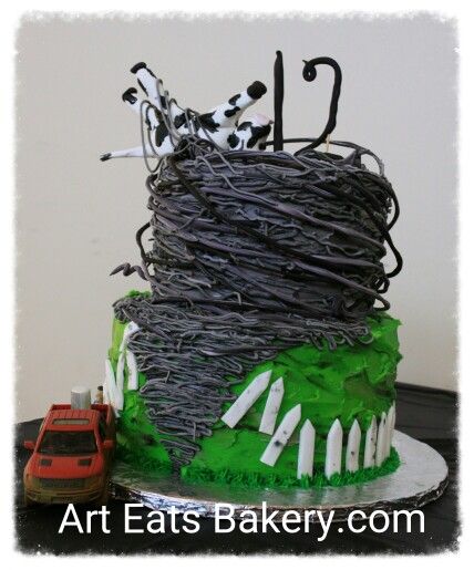 Twister movie themed birthday cake design with buttercream grass edible picket fence, tornado and cow. The pick up truck is not edible. Http://www.arteatsbakery.com 2830 Wade Hampton Blvd, Taylors, SC 29687 #cupcake #yeahthatgreenville #eatthatgreenville #birthday #birthdaycake #greatupstate #brownies #cake #pastry #taylors #greenville #Simpsonville #Spartanburg Tornado Themed Cake, Tornado Cake Design, Fournado Birthday Cake, Two Nado Birthday Cake, Twister Movie Themed Party, Tornado Themed Party, Twonado Birthday Cake, Tornado Birthday Cake, Tornado Cake Birthdays