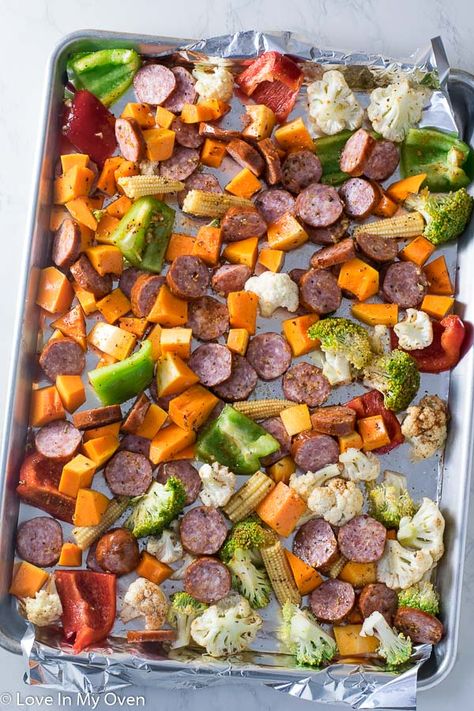 This one pan sausage and veggies dinner is the EASIEST meal you will ever make! Bright, flavorful and colorful vegetables with a simple spice mix roast up beautifully with some sliced garlic sausage! Try these sheet pan sausage and veggies for a weeknight win! // easy sausage recipes // smoked sausage and roasted vegetables // low carb one pan meals Sheet Pan Sausage And Veggies, Pan Sausage And Veggies, Sausage Sweet Potato, Sheet Pan Sausage, Sausage And Veggies, Potato Broccoli, Clean Meal Prep, Olive Oil Garlic, Clean Eating Recipes For Dinner