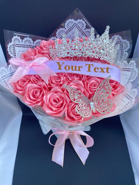 Beautiful handmade satin rose bouquet. Great for anniversaries, birthdays, holidays, weddings, graduations or simply to show someone you're thinking of them.  This item comes with an option to add a beautiful silver tiara and a personalized ribbon. Please don't hesitate to message us with questions or custom requests. Dimensions are included in the pictures, but depend on the number of roses selected. The pictured bouquet has 24 roses for reference. Please check out the rest of our store: https: Happy Birthday Flowers Bouquet, Bling Wedding Bouquet, Foam Flower Bouquet, Ribbon Rose Bouquet, Quinceanera Flowers, Bouquet Sizes, Bouquet Mothers Day, Satin Bouquet, Ribbon Rose Bouquets