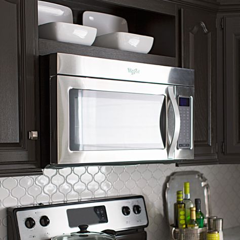 Create new space in your kitchen. Free up counter space by swapping your countertop microwave for an over-the-range model. Then turn a slice of cabinet space above the microwave into an attractive display shelf. Microwave Above Stove, Kitchen With Open Shelving, Microwave Storage, Hgtv Kitchens, Update Kitchen Cabinets, Kitchen Cabinets Pictures, Microwave Shelf, Microwave Cabinet, Update Cabinets