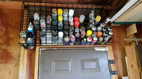 I used two 24" x 48" retail display grid walls (with 3" squares) to make an aerosol can storage rack above the door in the garage.  This has 128 spot for cans, tubes, etc.  I bought the grid walls online from ULine.com Aerosol Can Storage, Spray Can Storage, Storage Workshop, Basement Organization, Outdoor Studio, Tiny House Camper, Tool Board, Garage Basement, Garden Garage