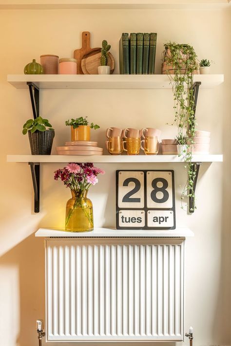 Shelf Styling ideas - we turned this radiator wall into a stylish corner of the kitchen by adding shelves, colourful crockery in pink and yellow and lots of plants. Try this for your home interiors and home decor. A happy shelfie design indeed. Kitchen Radiator, Radiator Shelf, Cool Shelves, Kitchen Shelf Decor, Kitchen Cupboard Doors, Pastel Color Schemes, Rust Oleum, Shelf Styling, Kitchen Shelves