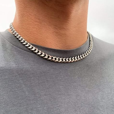 A thick Silver chain, Designed for daily wear. Chunky stainless steel cuban link - a real statement piece that will survive the test of time.DETAILSThickness: 8MMClosure: Lobster ClaspMaterials: Made from Stainless Steel / 18K Gold PVD PlatingChain style: CubanLifetime WarrantyPackaging: Packed in a Twistedpendant Jewellery PouchHypoallergenicSIZE DETAILSThe model is wearing a 20" in the single chain image and 18" / 20" / 22" in the three chain image.Available in lengths: 18" / 20" / 22" / 24"QUALITY ASSURANCEThis chain is made from Recycled Stainless Steel (Surgical Grade 316L). This chain will not tarnish, rust or turn your skin green. Available in multiple lengthsAvailable in silver or goldAvailable with a gift box Stainless steel Thick Silver Necklace, Chain Necklace Men, Thick Necklace, Mens Chain, Necklaces For Men, Silver Chain For Men, Stainless Steel Chain Necklace, Mens Chain Necklace, Necklace Men