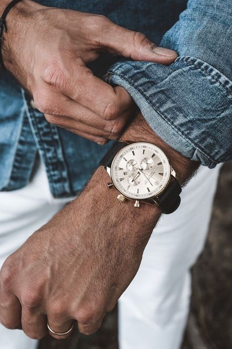 Thanks @about.marvin for this awesome photo! This is a gorgeous timepiece, designed by Dane Dapper in Denmark with careful attention to the details. If you look closely, you’ll see concentric circles and a grid pattern on the white dial. Framed by gold-toned bezel and lugs, the black leather strap, easily interchangeable, lends it a nice, stylish contrast. #trendhim #menstyle #menswatch #danedapper #urbanstyle #gentlemanstyle #watch #guyswatch Mens Watch Photography, Watch Photoshoot, Watch Painting, Lifestyle Jewelry, Watch Photography, Timeless Watches, Mens Fashion Watches, Mens Workwear, Watch Photo