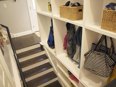 Tuck a mudroom anywhere you can find space, even along the stairs Shelf In Stairwell, Stairwell Entryway Ideas, Hidden Mudroom, Stairwell Entryway, Under Stairs Ideas, Stairway Storage, Entry Remodel, Basement Stairway, Split Entry Remodel