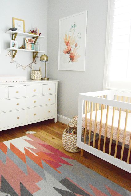 Feminine and fun are the best ways to describe this adorable girl’s nursery. Recreate this room design with a colorful aztec rug, pops of coral decor, and modern gold accents! Benjamin Moore Gray, Ideas Habitaciones, Stylish Nursery, Ideas Hogar, Gender Neutral Nursery, Project Nursery, Baby Bedroom, Nursery Inspiration, Baby's Room