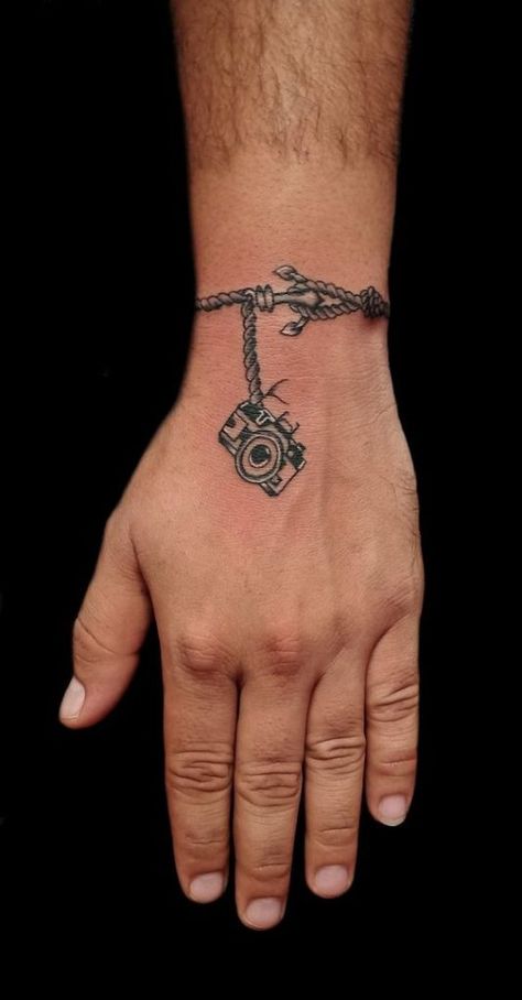 Unique Men’s Wrist Tattoos: Ideas for Personal Style and Expression Mens Wrist Band Tattoos, Mens Bracelet Tattoo For Men, Wrist Hand Tattoo Men, Wrist To Hand Tattoo Men, Small Tattoos For Men On Wrist, Men’s Wrist Tattoo Ideas, Hand And Wrist Tattoos For Guys, Wrist Bracelet Tattoo For Men, Meaningful Armband Tattoos For Men