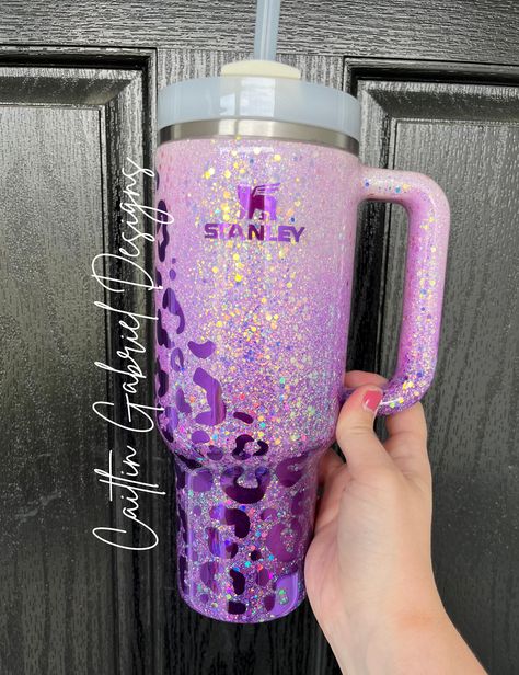 "TikTok Leopard Print Ombre Tumbler - purple pictured, other color schemes available by request!  If you are wanting the cup in the LISTING PHOTO you MUST select the option \"Stanley 40 oz\" from the drop-down. I offer multiple cup styles with this design. If you have any questions feel free to reach out!  Unless otherwise requested Stanley and Simple Modern tumblers will be made using a cream base cup.  The tumbler is sealed with epoxy to give a glass-like finish.  CARE INSTRUCTIONS: -HAND WASH Epoxy Cup Designs, Epoxy Stanley Cup, 40oz Tumbler Ideas, 40 Oz Tumbler Ideas, Tumbler Cup Design Ideas, Custom Stanley Tumbler, Epoxy Water Bottle, Purple Stanley Cup, Stanley Cup Designs