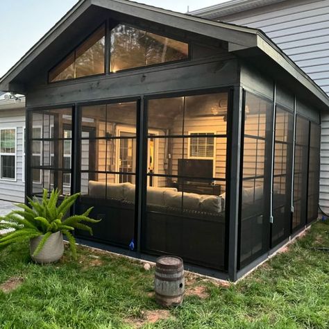 How gorgeous is this custom designed 3-season room in Fort Mill, SC? These homeowners wanted to create a modern three-season porch to enjoy year-round. They decided on vertical 4-track windows to enhance the space and allow for optimal usage. The black trim of the door and windows paired with the dark brown stain brings a sleek and finished look to the porch. 3 Season Room With Wood Stove, Three Seasons Room, 4 Seasons Room, 3 Seasons Room, 3 Season Porch Ideas, Enclosed Patio Ideas, Travertine Patio, Screened In Porch Diy, All Season Room