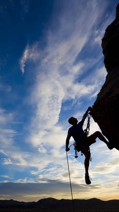 Download Silhouetted Man Climbing A Rock Wallpaper | Wallpapers.com Climbing, A Man, Wallpapers