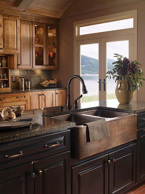 Who says you can't mix woods? This cozy, masculine kitchen goes all-in with both maple and walnut cabinetry and a deep, oak-front farmhouse sink. French doors provide just enough light to show off the room's varied textures – Affordable Rustic Kitchen, Kitchen Sink Decor, Plant Arrangement, Copper Kitchen Sink, Rustic Kitchen Cabinets, Decor Ikea, Rustic Kitchen Design, Farmhouse Kitchen Design, Design Blogs