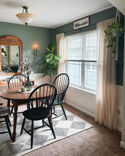 Partial dining room reveal! 🕯️🙌🏼 There is plenty left to do, but if I said I was LOVING it right now, that would be an understatement. 🥰 It’s the smallest room in the house at 10x10’, so I decided to reuse the perfectly moody @behrpaint in Peaceful Glade from the last house, and had to have this @loloi @chrislovesjulia “Francis” rug in Beige/Charcoal.🤍 I also just inherited this beautiful knotty pine mirror from my aunt, and we found the round table on FB Marketplace when we moved in. 🥂 ... Small Open Living Room And Dining Room, Cozy Family Dining Room, Playroom In Dining Room, Dining Table By Window, Shared Living And Dining Room, Dining Room Turned Sitting Room, Kitchen Dining Room Combo Layout, Small Apartment Dining Room, Small Dining Room Ideas