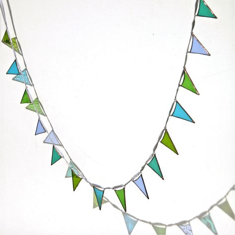 I often get asked to make my bunting as long as possible! so Im making a new length of 15 piece garlands using smaller, but very cute, glass flags. For this bunting Ive used 5 different glasses in teal , lush greens, and blues. The glass has a range of textures, dimples and striations - Small Stained Glass Projects, Stained Glass 3d, Garland Home Decor, Stain Glass Art, Glass Garland, Window Suncatchers, Glass Art Projects, Bunting Garland, Stained Glass Projects