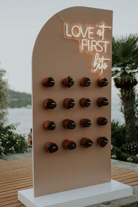 Love at first bite donut wall design. Diy Wedding Rentals, Candy Table Display, Donut Wall Wedding, Treat Wall, Doughnut Wall, Party Rentals Business, Donut Ideas, Candy Wall, Donut Tower