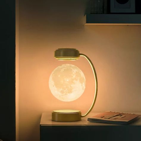 Transform your living space into a celestial haven with the Levitating Moon Lamp. This marvel of design and technology brings the ethereal beauty of the moon right into your home, offering an enchanting and futuristic touch to your interior decor. MAGNETIC LEVITATION TECHNOLOGY – Experience the wonder of magnetic levitation as this lamp defies gravity. The moon floats and spins freely above its base, creating a captivating and serene ambiance in any room. TOUCH SENSOR CONTROL – With its intuitiv Lights Bedroom Ideas, Floating Planet Lamp, Levitating Moon Lamp, Retro Flip Clock, Magnetic Moon Lamp, Moon Light Lamp Wall, 3d Led Moon Lamp, Cute Night Lights, Light Bulb Lamp