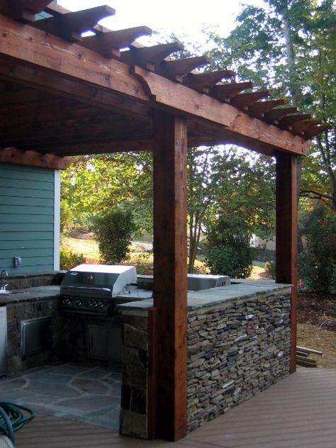 enclosed outdoor kitchen. Could build the half wall out of brick or cinderblocks(not as pretty) or even use prefab picket fence sections. Enclosed Outdoor Kitchen, Brick Counter, Diy Outdoor Kitchens, Arbors And Pergolas, Grow Blackberries, Wall Pergola, Enclosed Kitchen, Pergola Roof, Pergola Outdoor