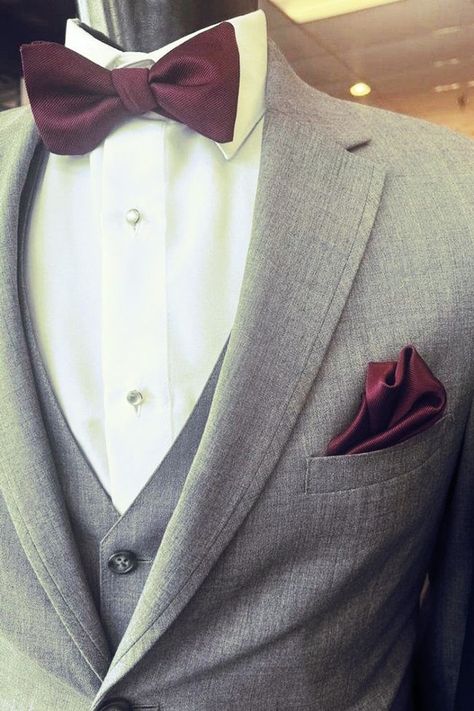 Grey suit with burgundy accessories and bow tie | Groom tuxedo | Everything You Should Know About Menswear & Trends Before You Order Your Wedding Look— Savvi Formalwear & Bridal | Raleigh, North Carolina Wedding Dresses Grey Suit With Bow Tie, Grey Suit With Burgundy, Grey Suit Red Tie, Light Grey Suit Men, Maroon Wedding Suit, Light Gray Wedding, Bow Tie Groom, Burgundy Accessories, Bow Tie Suit