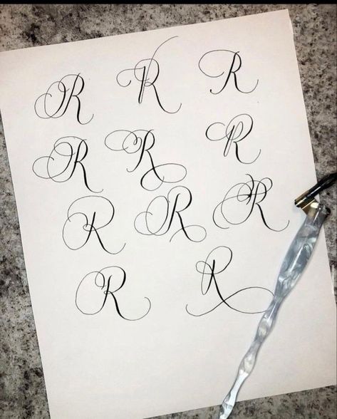 Flourishing calligraphy letter R with gold ink on textured Fonts Alphabet Cursive, Calligraphy R, Flourishing Calligraphy, Cursive Letters Font, Letter R Tattoo, Vintage Cursive, Cursive Fonts Alphabet, Alphabet Cursive, Fonts Elegant