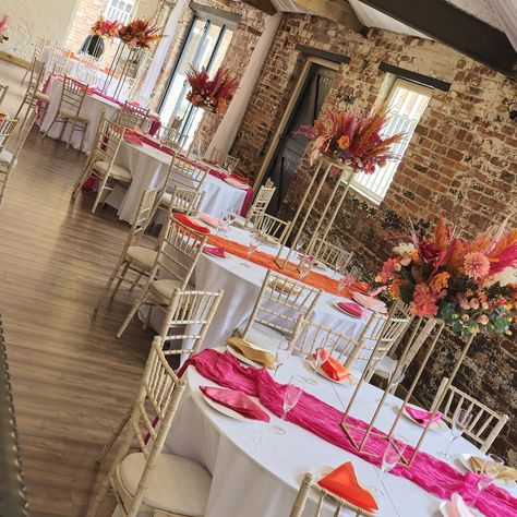 Beautiful pampas centerpieces placed on metal table stands/plinths Made with a mix of pink and orange pampas grass, dried flowers, and the single stem flowers are all artificial. With my custom palms to match the wedding scheme. I actually show myself sometimes 😆. I absolutely loved making these decorations. My workshop is completely bare now they have all gone. If you would like to discuss your wedding flowers, please send a message and I would be happy to help. All of these decorat... Pampas Centerpieces, Pink Table Settings, Pink Wedding Receptions, Orange And Pink Wedding, Stem Flowers, Orange Party, Ceremony Seating, Party Inspo, Pink Table