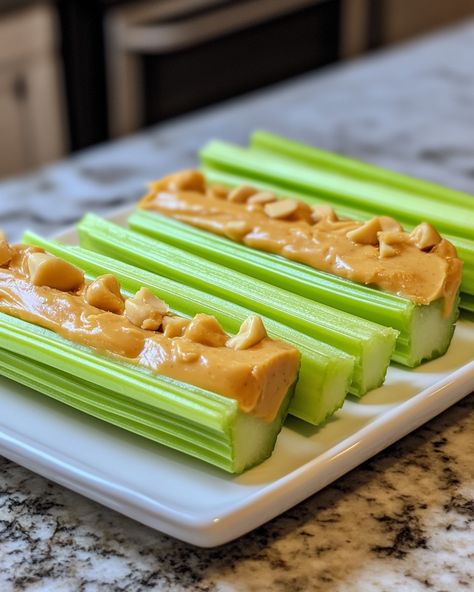 This classic snack brings back so many childhood memories! It’s simple, healthy, and always delicious!  Ingredients: - Fresh celery stalks - Creamy peanut butter - Raisins (optional)  For full preparation steps, please check the link in the first comment [👇] [👇].  This snack is perfect for a quick energy boost or a fun after-school treat. I love how crunchy the celery is with the smooth peanut butter—such a great combo!   #CelerySnacks #HealthyEating #PeanutButterLove #QuickEats #ComfortFood Celery Ideas Healthy Snacks, Celery Peanut Butter Snacks, Peanut Butter And Celery, Celery With Peanut Butter, Celery Snack Ideas, Celery And Peanut Butter, Celery Peanut Butter, Protein Food Recipes, Celery Snacks