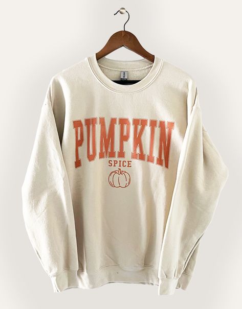 The perfect sweatshirt for lovers of fall! Warm your heart and embrace the fall season with our "Pumpkin Spice" Graphic Sweatshirt. This delightful and cozy sweatshirt is designed to capture the essence of autumn, making it the perfect addition to your seasonal wardrobe.PRODUCT SPECIFICATIONS*Screen printed ‘Pumpkin Spice’ on Crewneck Sweatshirt*Unisex Sizing*Online Only Cute Sweaters For Fall Teens, Preppy Fall Sweatshirts, Cute Fall Crewnecks, Halloween Sweater Ideas, Cricut Fall Sweatshirt Ideas, Cute Fall Sweatshirts, Sweatshirts Cricut, Fall Sweatshirt Ideas, Cute Fall Sweaters