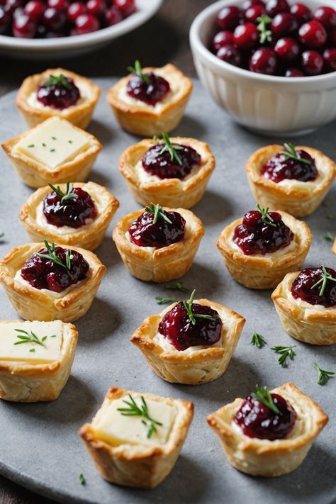 A photo of a  Cranberry Brie Bites which is a type of thanksgiving appetizers Fancy Fall Appetizers For Party, Mini Brie Bites Recipes, Easy Christmas Orderves, Brie Appetizer Thanksgiving, Prime Rib Appetizer Holidays, Holiday Party Small Bites, Thanksgiving Appetizers With Cranberry, Stuffing Bites Appetizers, Thanksgiving Brie Recipes