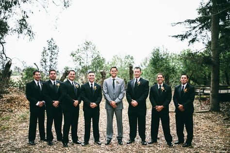 Black suits for groomsmen  light grey for the groom. Really spotlights the groom! Black And Grey Groomsmen Attire, Black And Gray Groomsmen Attire, Grey And Black Groomsmen Suits, Groom In Grey Groomsmen In Black, Black Groom Suit Gray Groomsmen, Grey Groom Black Groomsmen, Groom In Black Tux Groomsmen In Gray, Groomsmen Charcoal Grey, Gray Groom Black Groomsmen