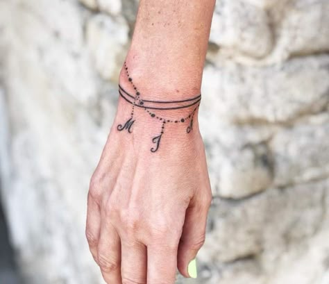 Initial Bracelet Tattoo, Charm Bracelet Tattoos, Ankle Bracelet Tattoos For Women, Bracelet Tattoo Wrist, Wrist Bracelet Tattoos For Women, Armband Tattoo Frau, Tattoo With Kids Names, Bracelet Tattoos With Names, Bracelet Tatoo