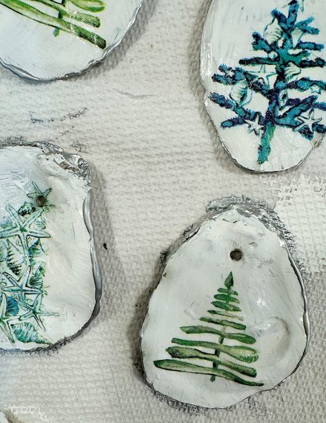 Creating oyster shell Christmas ornaments with paper napkins is an incredibly easy and enjoyable craft that combines natural elements with artistic flair. Painting Oyster Shells Diy Christmas, Oyster Shell Ornaments Diy Easy, Mod Podge Oyster Shells, How To Make Oyster Shell Ornaments, Santa Oyster Shell Ornament, Oyster Shell Crafts Diy Ideas, Oyster Shell Christmas Ornaments, Oyster Shells Diy, Shell Christmas Ornaments