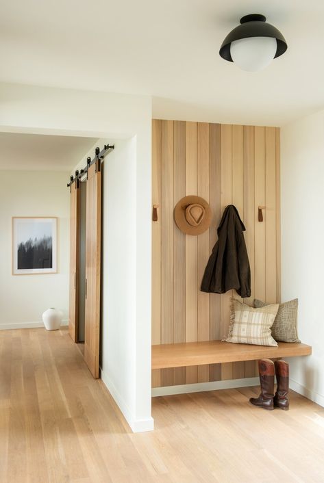 The natural wood paneling detail is carried throughout the house from the exterior siding, through the entry, and then into the great room for cohesion. Photo 1 of 14 in Modern Montana Retreat by Christine Callaghan. Browse inspirational photos of modern homes. Natural Wood Paneling, Entry Nook, Entrance Bench, Small Mudroom Ideas, Mudroom Remodel, Entryway Modern, Mud Room Entry, Diy Mudroom, Mudroom Entryway