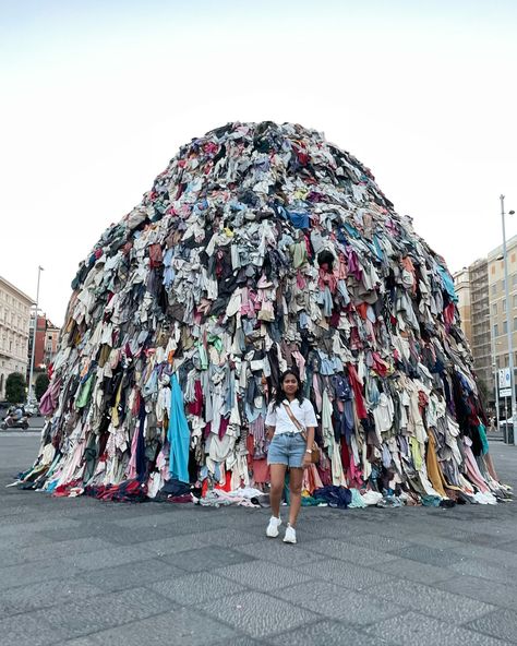 🌍✨ While exploring Europe last month, I found myself in Naples, standing before a towering symbol of modern consumerism—a giant Venus sculpture made from the mountains of discarded clothes. This striking commentary on waste stopped me and echoed the very ethos we cherish at Ruhmee. We strive to counteract the fast fashion cycle by creating sustainable, beautiful clothing that transcends seasons and trends. Each piece is crafted with care and intention, designed not only to last but to be che... Fast Fashion Photography, Overconsumption Core, Protest Fashion, Venus Sculpture, Fashion Waste, Fashion Cycle, Marble Arch, Cycling Fashion, Social Impact