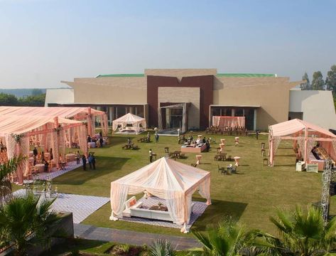 "The banquet hall of Cavanal Hill Resort is one of the wedding venues in Chandigarh where you can celebrate the marriage in the most exquisite manner. The grand bnquet hall of  can host up to 1200 people at once.  THE GOOD LIFE KEEPS GETTING BETTER AT CAVANAL HILLS RESORT. – 65000 SQ. FT. LAWN AREA. – 17000 SQ. FT. AC BANQUET HALL. – 12000 SQ. FT. COVERED KITCHEN AREA. – 25000 SQ. FT. FULLY WATER PROOF OUTDOOR DECOR. – 24×7 SECURITY & POWER BACKUP. – SPACE FOR 400+ CAR PARKING. Open Area Wedding Decoration, Indian Banquet Hall Design Exterior, Open Lawn Wedding Decoration, Marriage Lawn Design, Marriage Hall Design, Small Wedding Hall, Marriage Hall Decoration, Marriage Hall, Lawn Designs