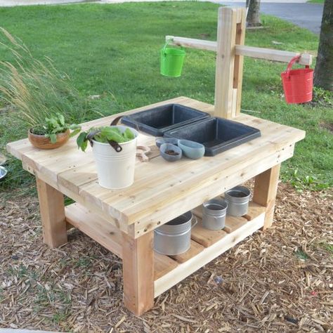 Sturdy outdoor table with wet play sinks and a bench top wooden scale set. A unique way to immerse children in mathematical learning outdoors. Please note that the scale has approximate accuracy only. The buckets are included and can be detached and used to carry materials for weighing. Made of natural North American Cedar.  Our lumber is North American Cedar which does not require any stain, and can last 15-20 years.  Cedar wood is porous, which protects it from changes in temperature, so it is Outdoor Play Kitchen, Kids Yard, Outdoor Play Space, Play Area Backyard, Outdoor Play Spaces, Backyard Kids Play Area, Play Garden, Diy Mud Kitchen, Kids Outdoor Play