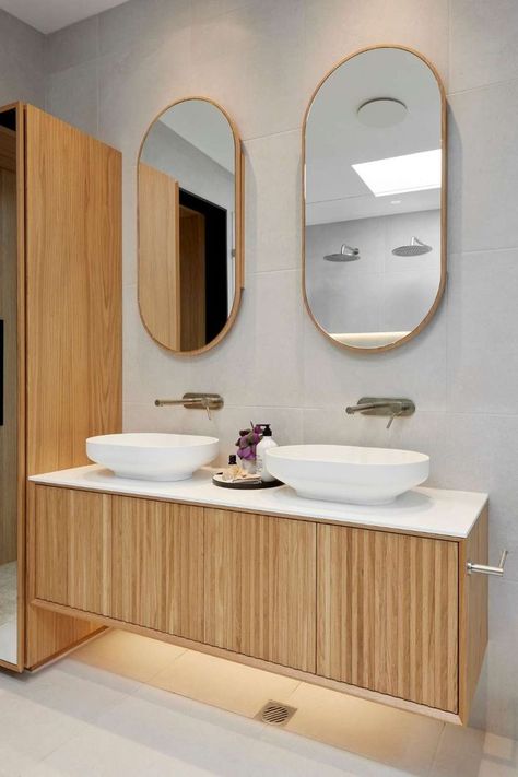 Luke & Josh kept their vanity choices consistent with their guest ensuite, including a beautiful timber ISSY Halo I vanity and two ISSY Blossom shaving cabinets, which they paired with the Z8 tallboy for extra storage. The twins paired Omvivo Venice 500 solid surface basins well to connect to the tactile bath and brushed nickel fixtures. See the whole room in the Project Gallery. Bathroom Tallboy, Master Ensuite Bathroom, Velux Skylights, Outdoor Bathtub, Hidden Spaces, Black Toilet, Master Ensuite, Concrete Basin, Outdoor Bath